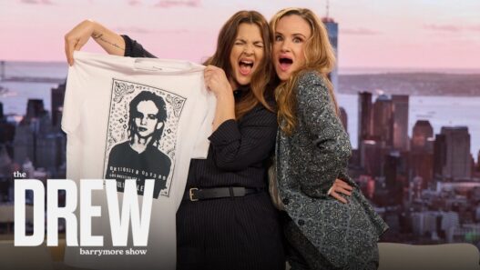 Juliette Lewis discussing her mug‑shot T‑shirt on The Drew Barrymore Show.