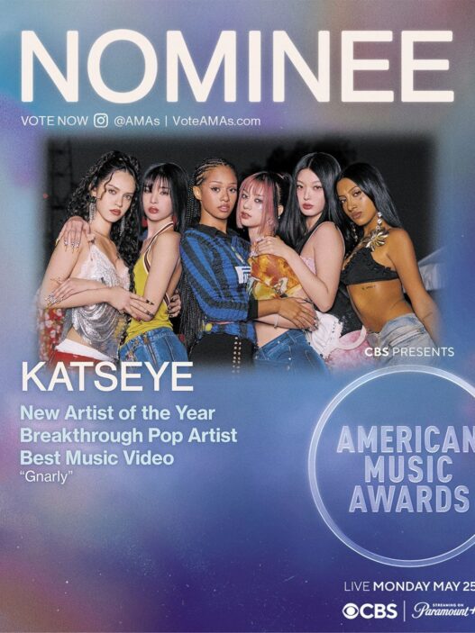 Poster advertising the American Music Awards with six women posing together; large NOMINEE text at the top and Katseye highlighted as New Artist of the Year nominee.