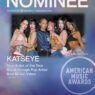 Poster advertising the American Music Awards with six women posing together; large NOMINEE text at the top and Katseye highlighted as New Artist of the Year nominee.