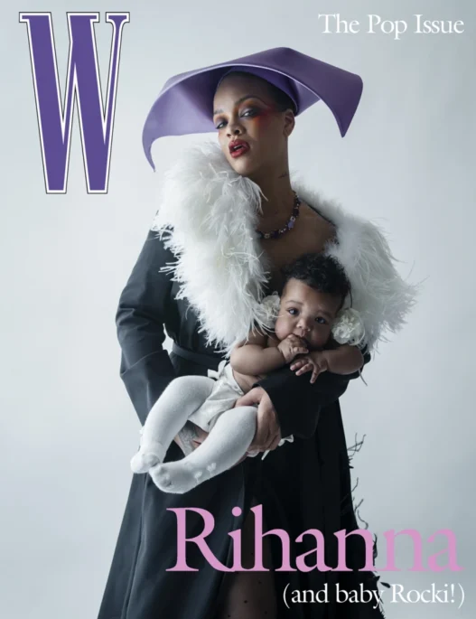Rihanna wearing a purple hat and a white feathered scarf, holding her baby on a W magazine cover.