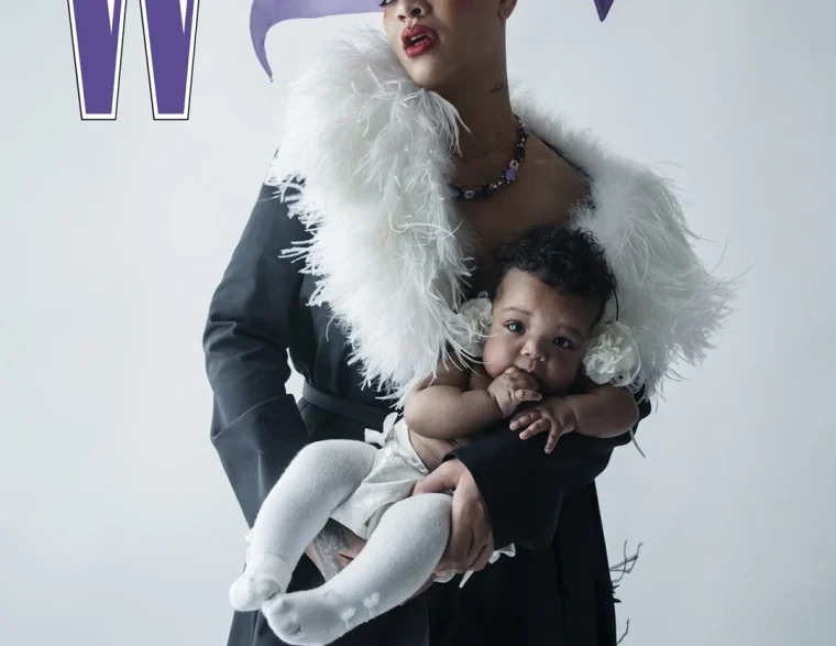 Rihanna wearing a purple hat and a white feathered scarf, holding her baby on a W magazine cover.