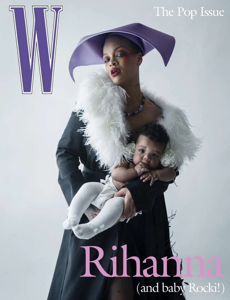 Rihanna wearing a purple hat and a white feathered scarf, holding her baby on a W magazine cover.
