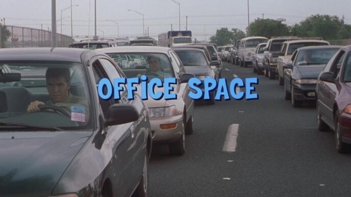 A scene from the 1999 film Office Space featuring characters in a software office setting.