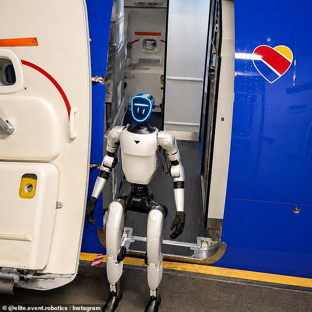 Humanoid robot standing on the boarding stairs at an open airplane door, blue exterior with a heart logo.
