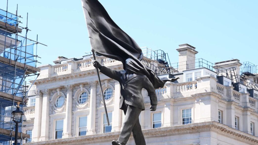 Banksy’s 25‑foot overnight statue of a suited man carrying a flag in Central London.