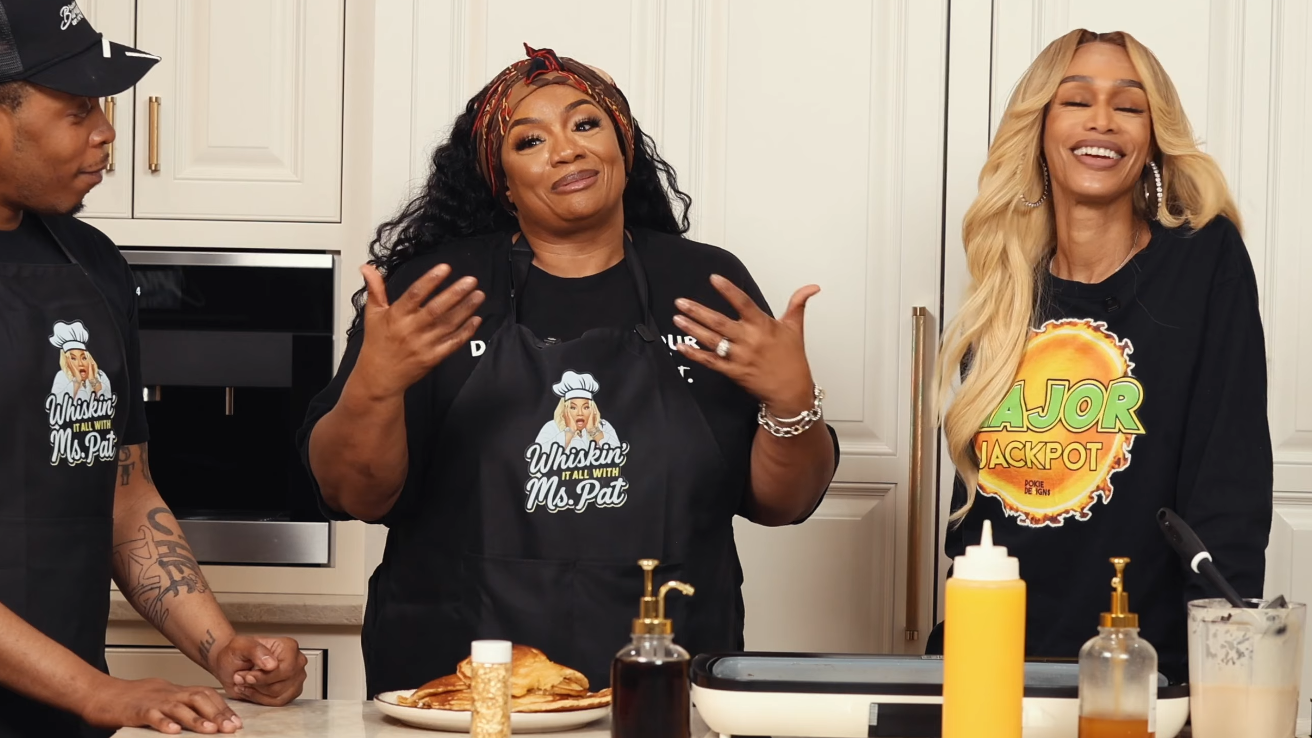 Ms. Pat and Tami Roman laughing and cooking together on the YouTube series “Whiskin’ It All.”