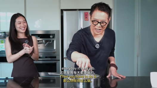 Jet Li cooking frozen dumplings while his daughter watches and playfully critiques him.