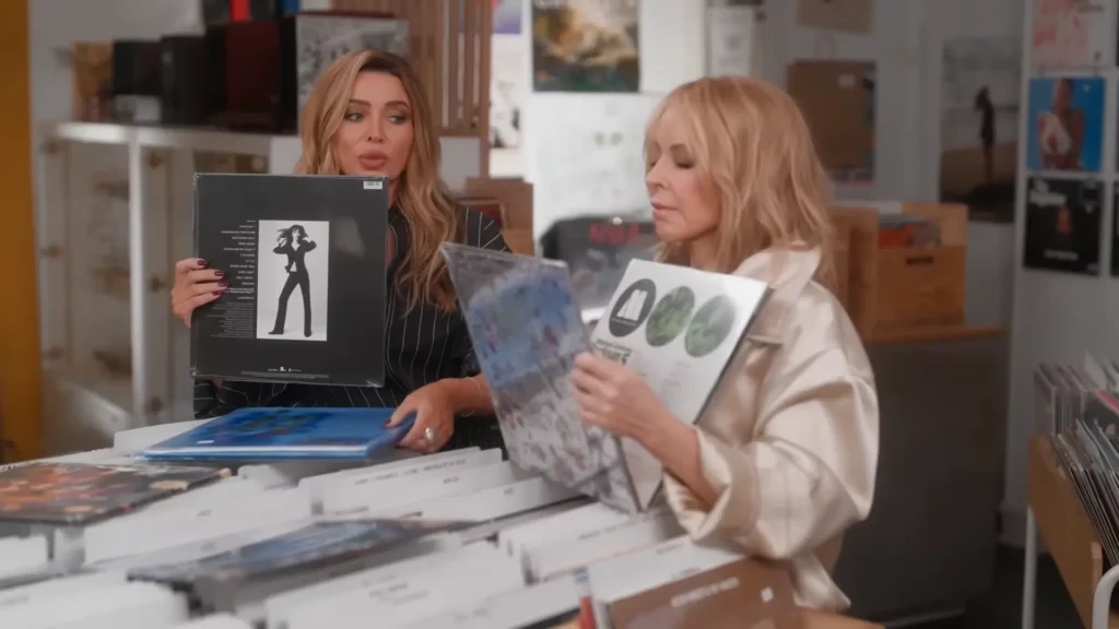 Kylie and Dannii Minogue laughing while record shopping for Netflix