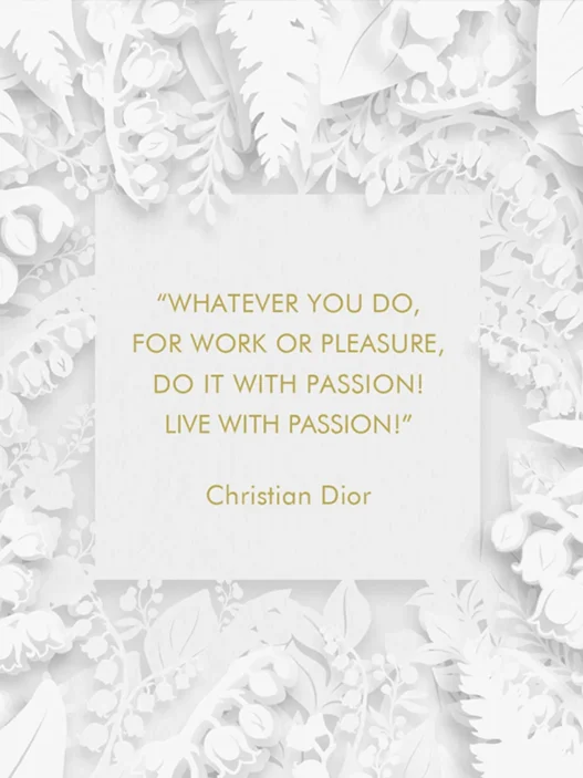 White floral papercut frame surrounds a white card with a gold Christian Dior quote: 'Whatever you do, for work or pleasure, do it with passion! Live with passion!'
