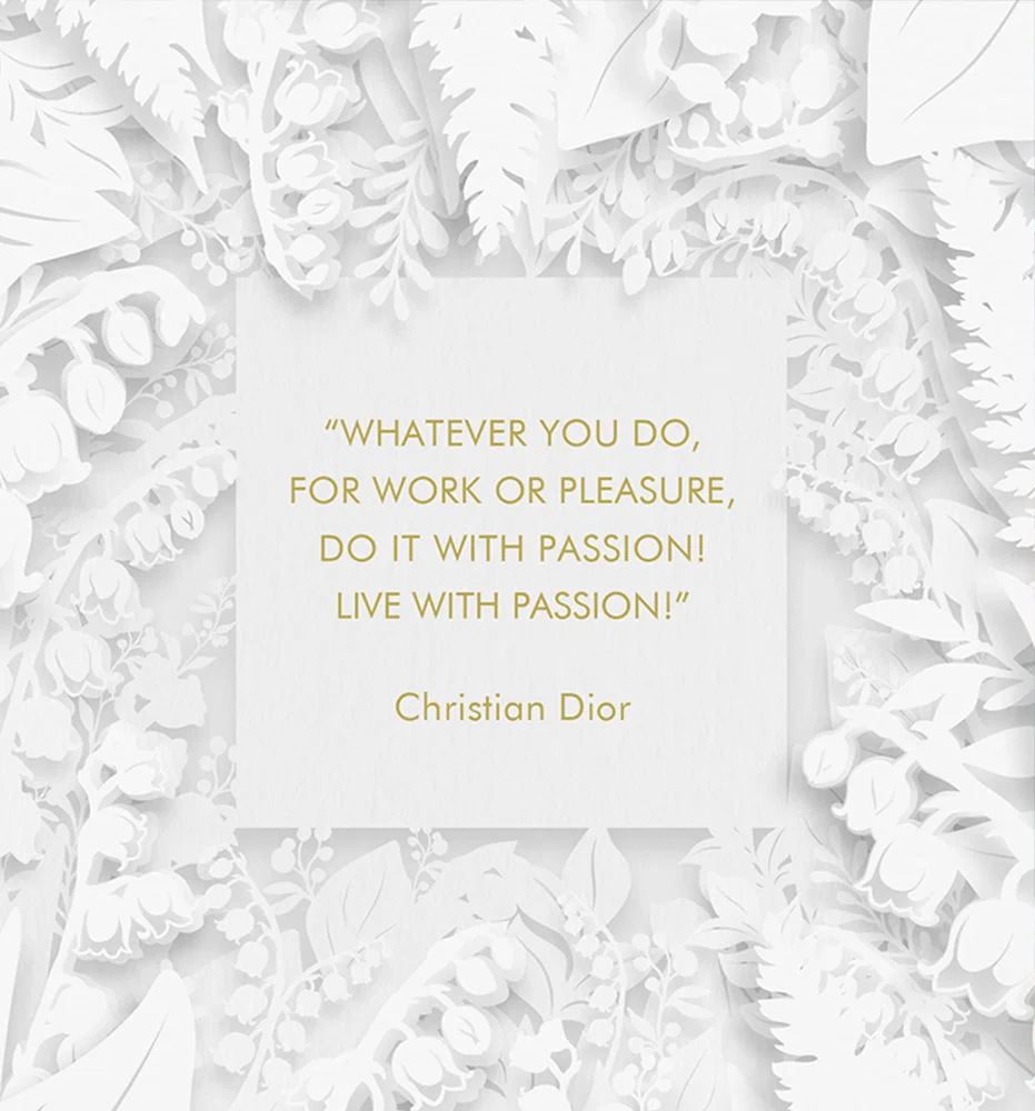 White floral papercut frame surrounds a white card with a gold Christian Dior quote: 'Whatever you do, for work or pleasure, do it with passion! Live with passion!'