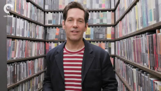 Paul Rudd holding films inside the Criterion Closet