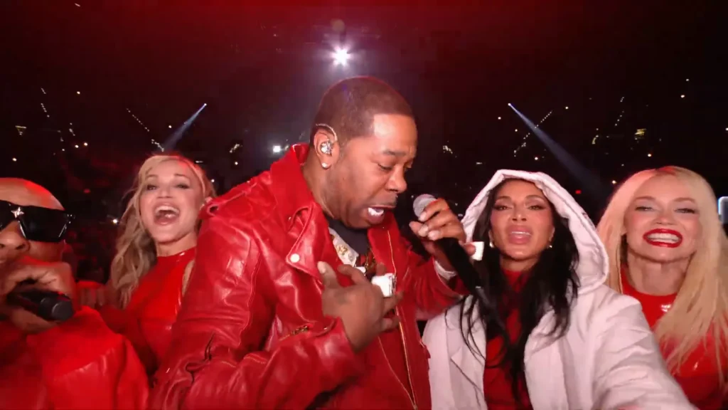 The Pussycat Dolls trio performing a high‑energy AMAs medley with Busta Rhymes joining for “Don’t Cha.”