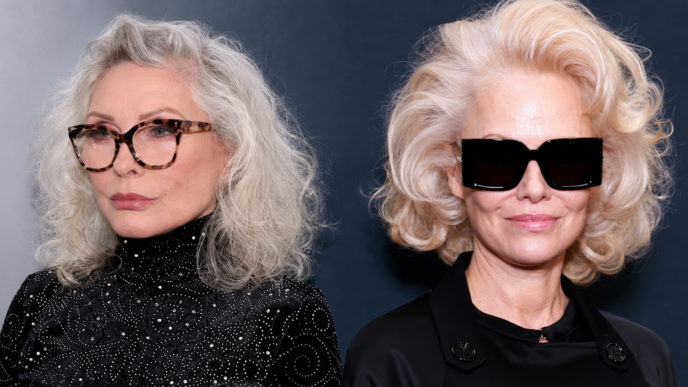 Side-by-side cropped headshot composite of Debbie Harry and Pamela Anderson in sleek black fashion looks, styled with silver and platinum blonde hair for an entertainment story header.
