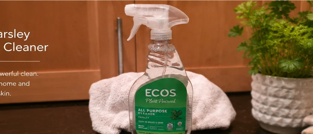 ECOS Parsley All Purpose Cleaner bottle on a kitchen counter with a towel behind it.