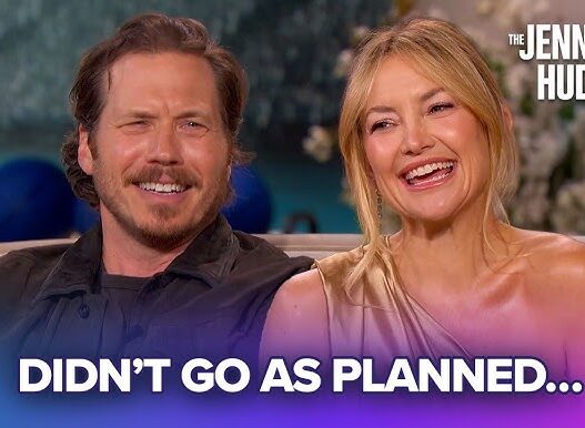 Two smiling talk-show hosts sit together on a set, with the caption 'DIDN'T GO AS PLANNED...' across the bottom.