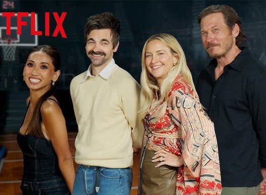 Netflix promotional photo: four people smiling and posing on a basketball court with the Netflix logo in the corner.