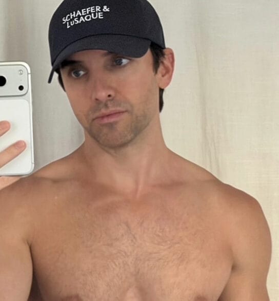 Paul W. Downs posing shirtless in a playful Instagram moment.