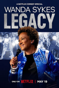 Poster for Wanda Sykes: LEGACY, a Netflix comedy special. Wanda Sykes holds a microphone, wearing a blue varsity jacket, with 'LEGACY' in large letters above. Premieres May 19 on Netflix.