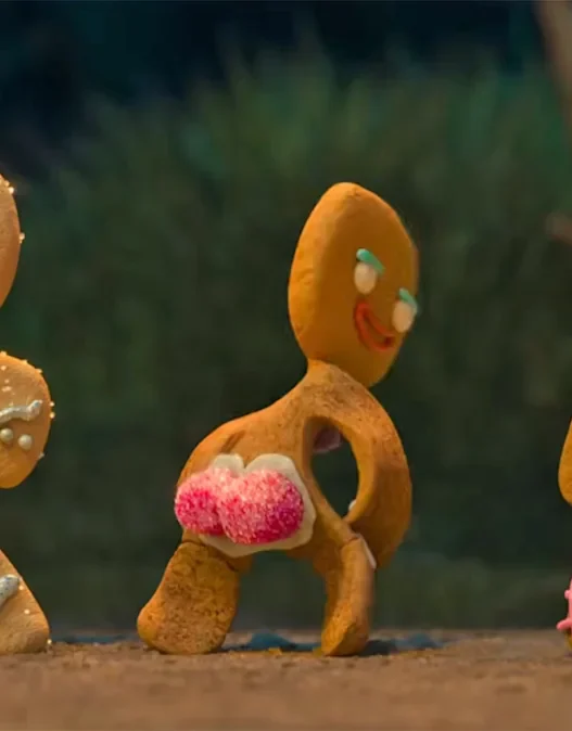 Three gingerbread characters modeling colorful outfits in the Shrek 5 teaser trailer