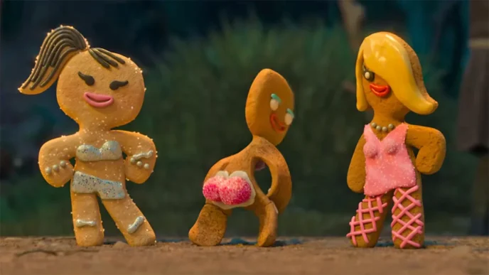Three gingerbread characters modeling colorful outfits in the Shrek 5 teaser trailer