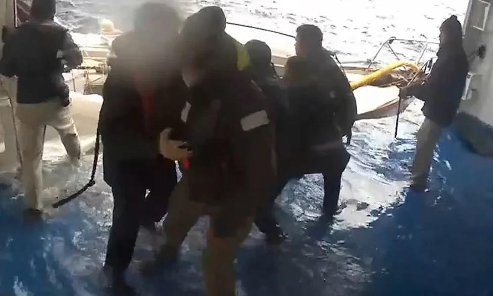 Cruise ship rescue of a stranded sailor in rough Pacific Ocean waters