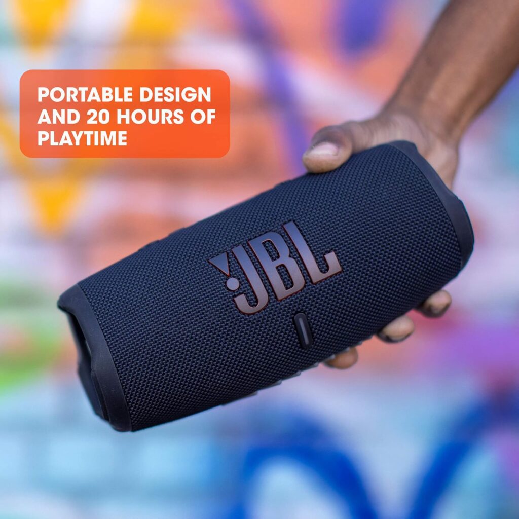 JBL Charge 5 portable Bluetooth speaker shown with its charging cable.