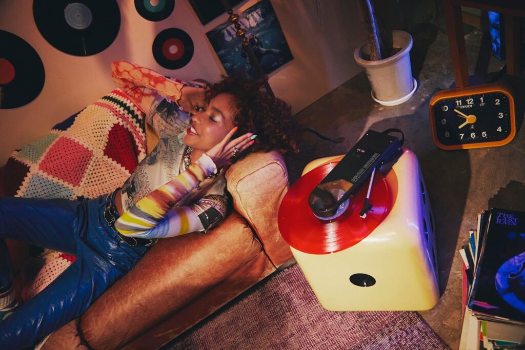 Audio-Technica Sound Burger portable Bluetooth turntable displayed with a vinyl record.