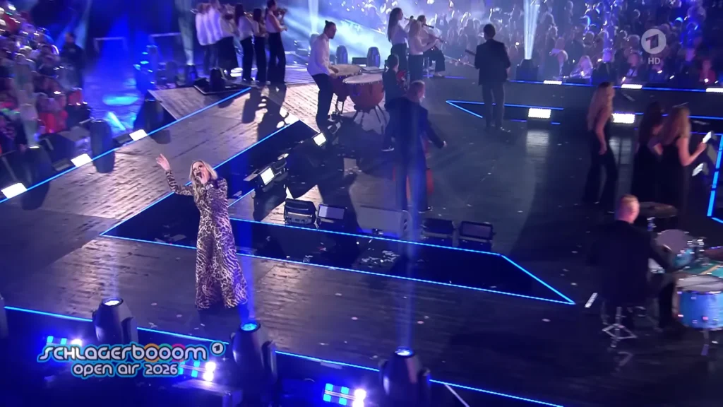Anastacia performing under bright stage lights at Schlagerbooom Open Air