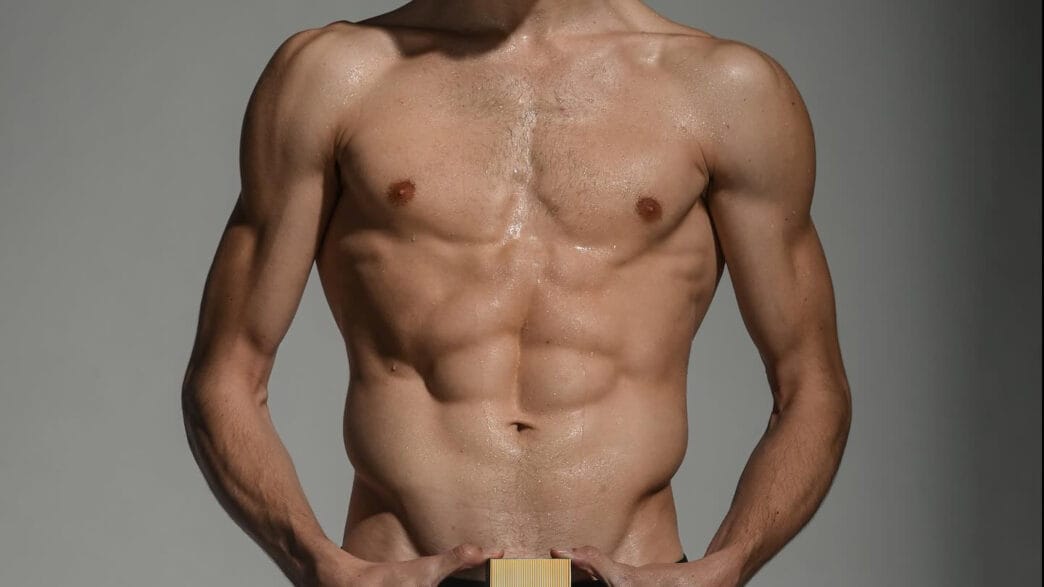 Austin Miller photographed by Frank Louis for L’Homme México with Tom Ford Noir visible in the mirror.
