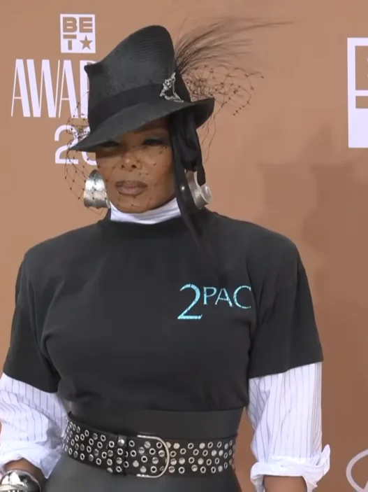 Janet Jackson arriving at the BET Awards 2026 red carpet wearing a vintage Tupac T-shirt and veiled fedora