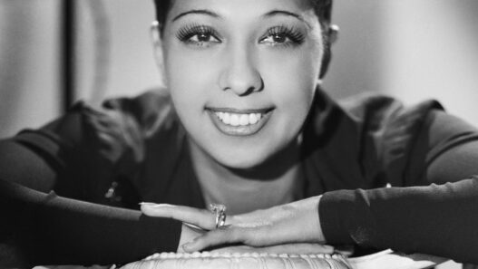Josephine Baker smiling in a jeweled stage costume during her legendary performance career