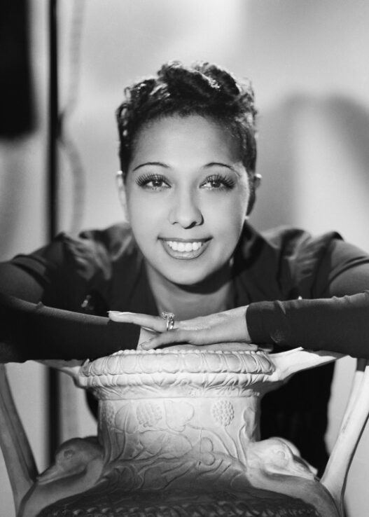 Josephine Baker smiling in a jeweled stage costume during her legendary performance career
