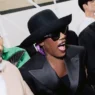 Grace Jones at the CELINE Spring Summer 2027 men’s show wearing a charcoal suit bowler hat and sunglasses