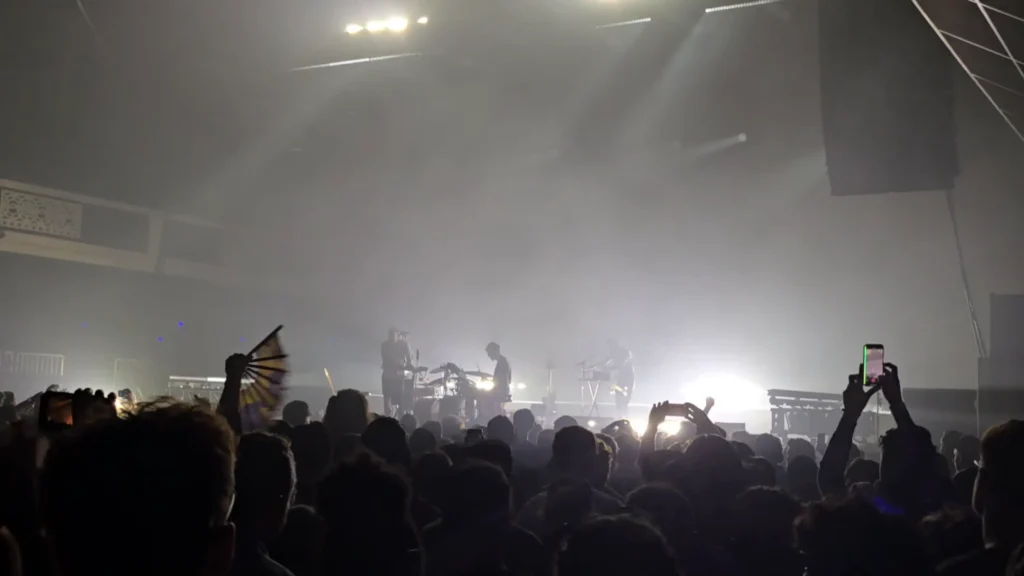 Caribou performing live at Shrine Expo Hall in Los Angeles during an intense light show
