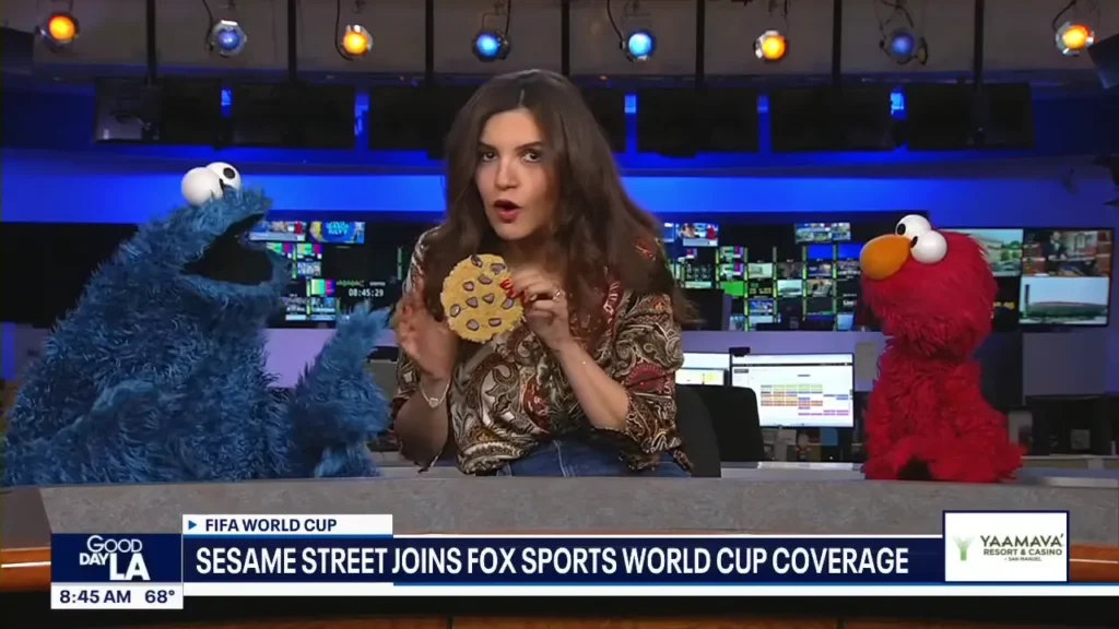 Elmo and Cookie Monster appear with the FOX 11 Los Angeles hosts during their World Cup visit