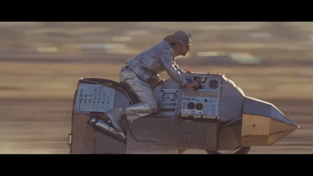 LA Priest riding his custom-built synth-bike through the Joshua Tree desert