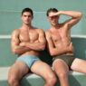 Bazaar Sport model posing in white swim briefs against a turquoise wall for a chest workout feature