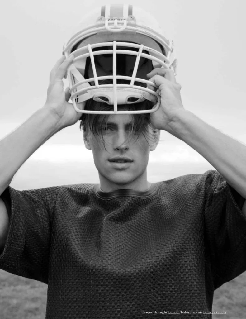 Bazaar Sport model wearing a rugby helmet and textured black leather Bottega Veneta T-shirt