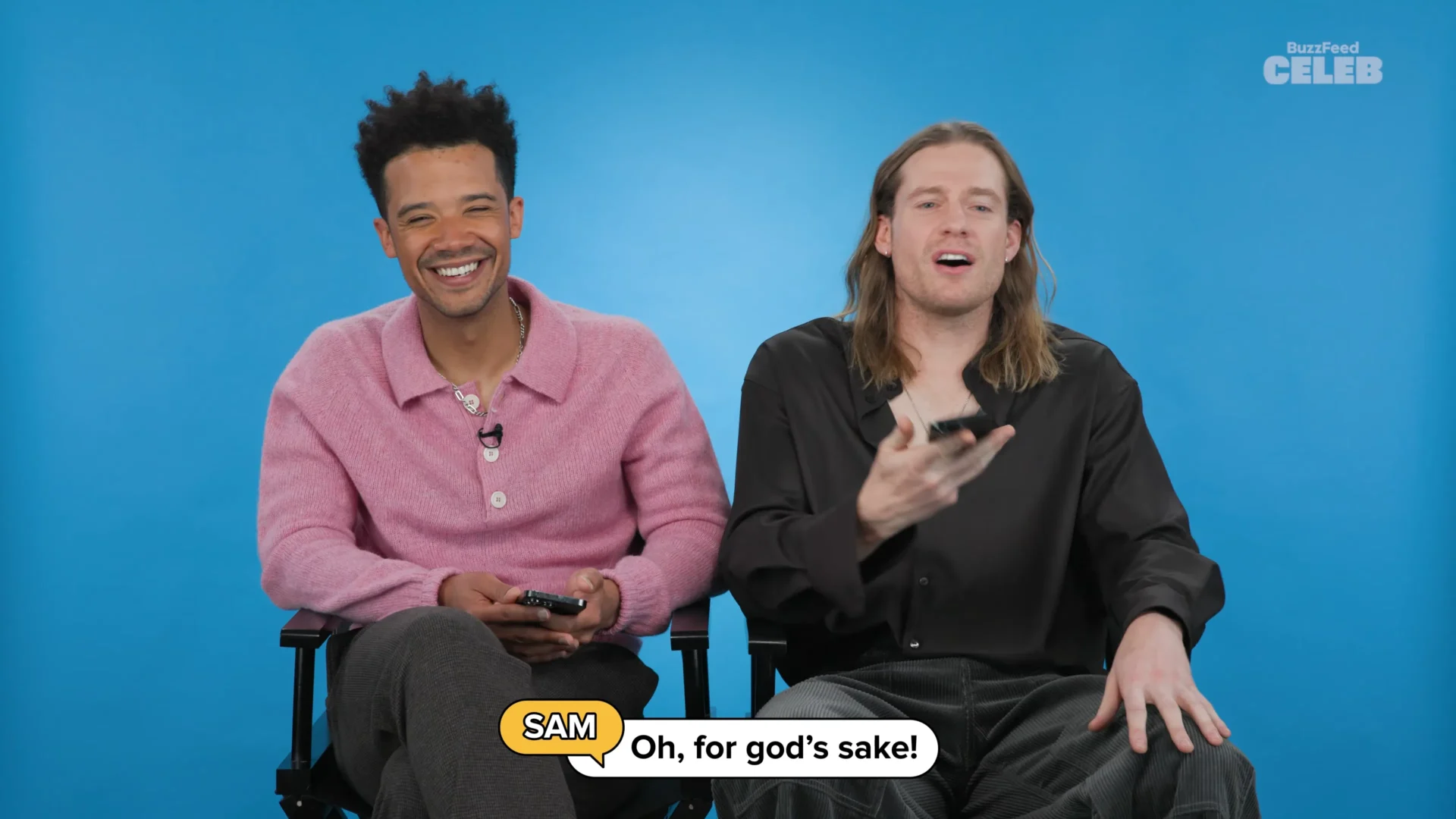Sam Reid and Jacob Anderson sitting together while reading BuzzFeed Celeb Thirst Tweets