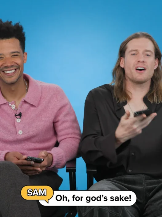 Sam Reid and Jacob Anderson sitting together while reading BuzzFeed Celeb Thirst Tweets