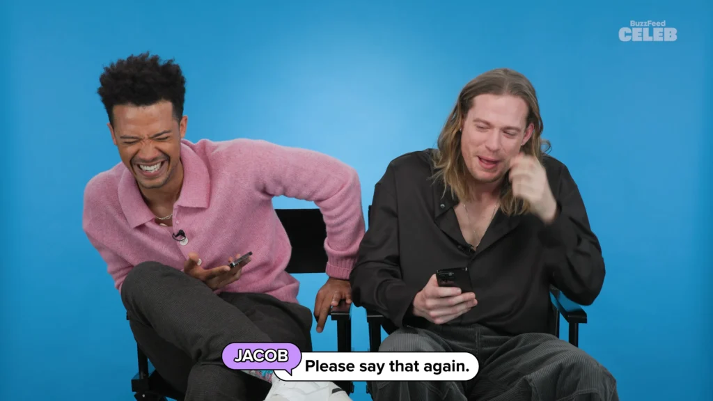 Sam Reid and Jacob Anderson sitting together while reading BuzzFeed Thirst Tweets