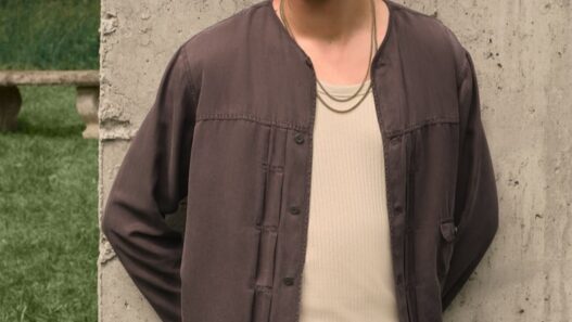 Anarcius Jean wearing an olive floral lace camp shirt for the &Kin by Kith Summer 2026 collection