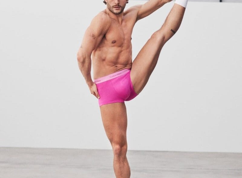 Sam Salter poses shirtless in bright green Calvin Klein Pride boxer briefs