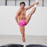 Sam Salter poses shirtless in bright green Calvin Klein Pride boxer briefs