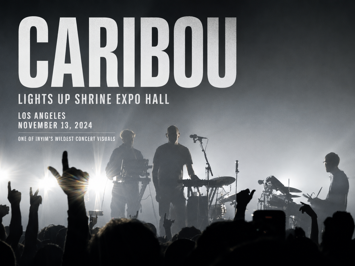 Caribou performs live at Shrine Expo Hall in Los Angeles on November 13, 2024, silhouetted against dramatic backlighting as the crowd raises their hands.