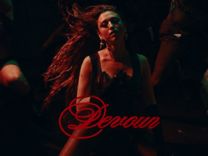 Rêve in a dark red-and-green nightclub scene with the song title “Devour” written in red script across the lower image.