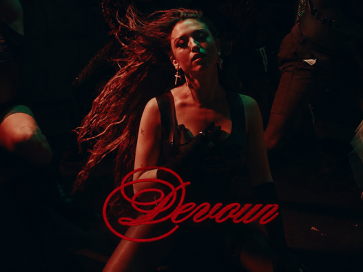 Rêve in a dark red-and-green nightclub scene with the song title “Devour” written in red script across the lower image.