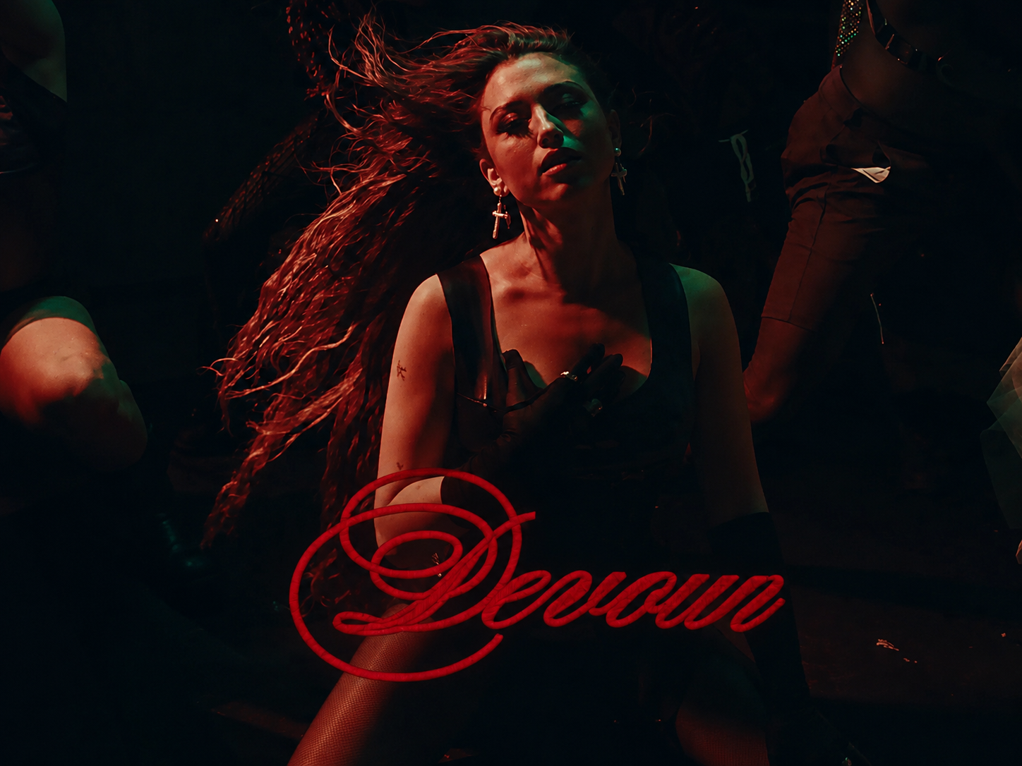 Rêve in a dark red-and-green nightclub scene with the song title “Devour” written in red script across the lower image.