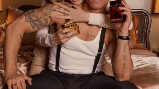 Madonna and Alberto Guerra look toward the camera while reviewing a photograph on the Dolce and Gabbana The One campaign set