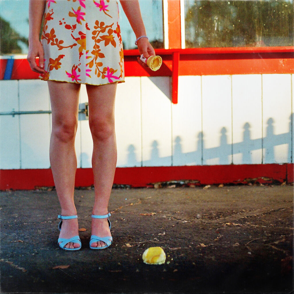 Frankie June in a floral dress holding an ice cream cone for Make It Through June